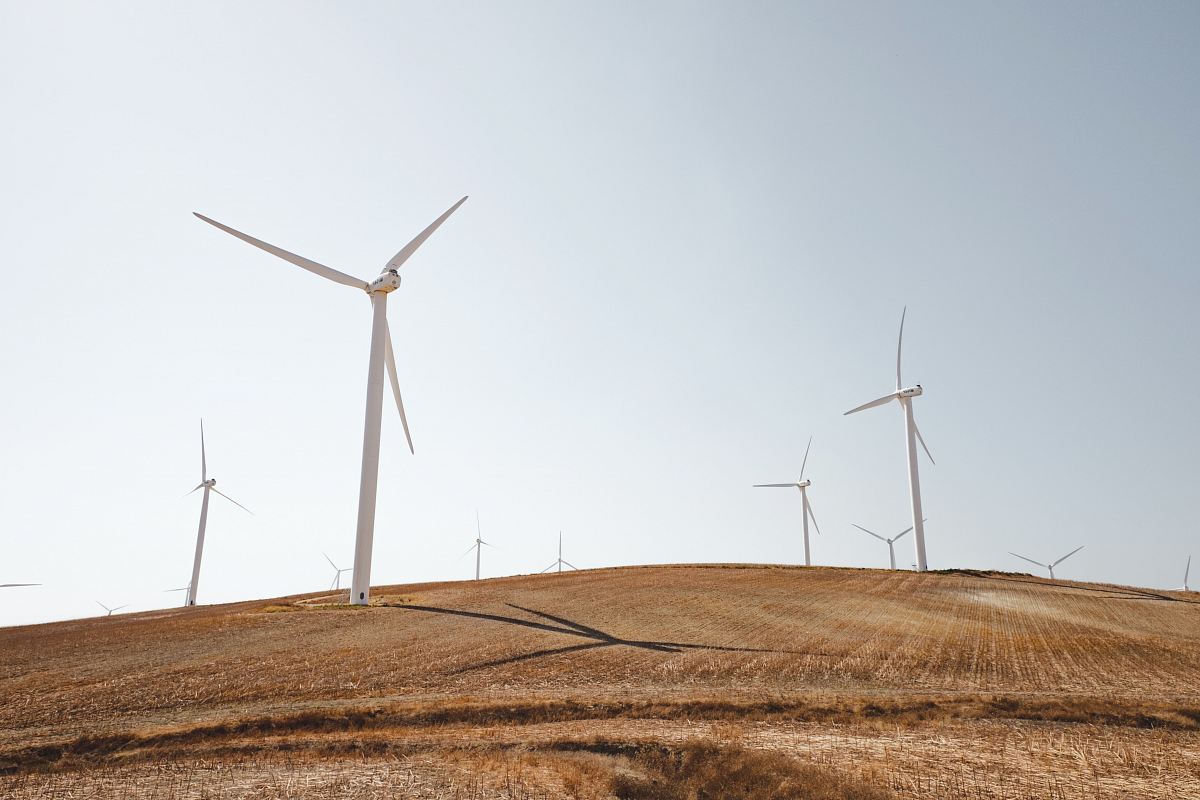 white electric windmills during daytime